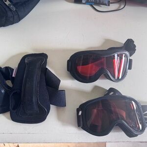 Two pair of kids ski goggles and one pair of kids wrist giards
